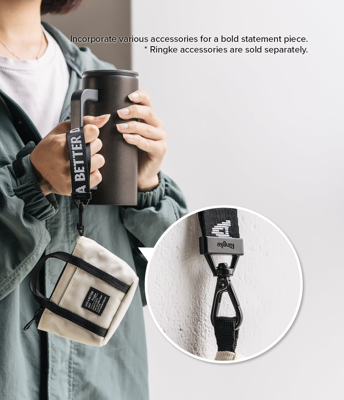 Mini Pouch | Tote Bag - A person holds a tumbler with a branded strap attached to a small beige tote pouch, with a close-up of the clip.