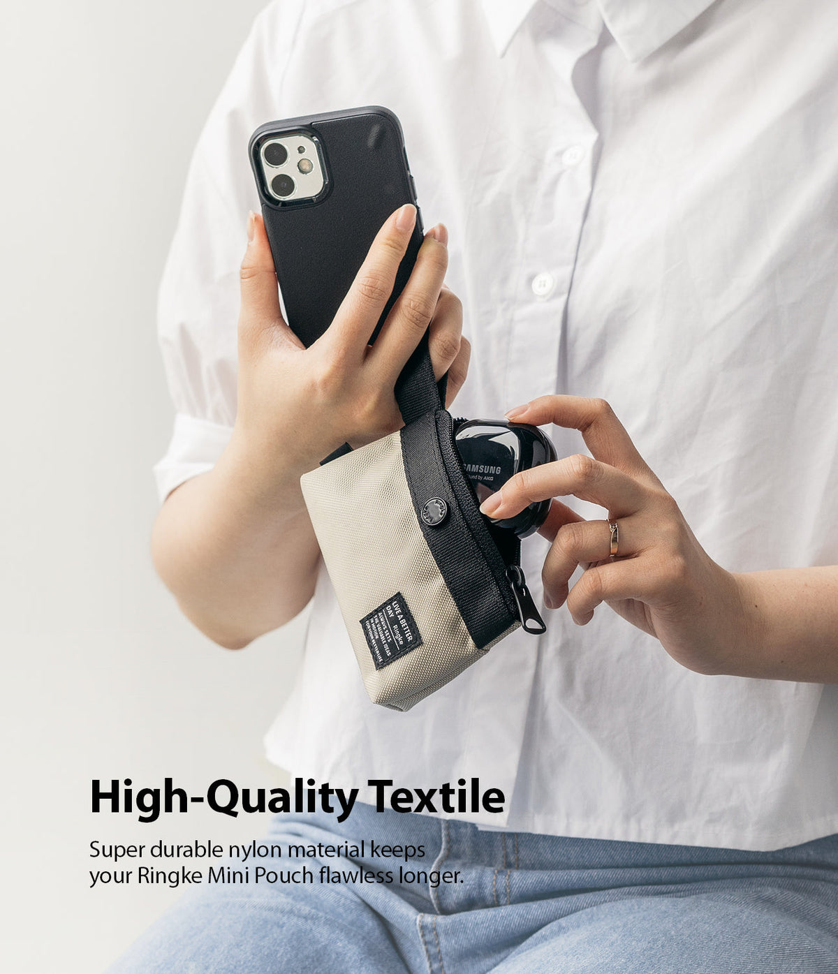 Mini Pouch | 2-Way Bag Miniature - Person holding a beige and black mini pouch attached to a smartphone, inserting wireless earbuds.