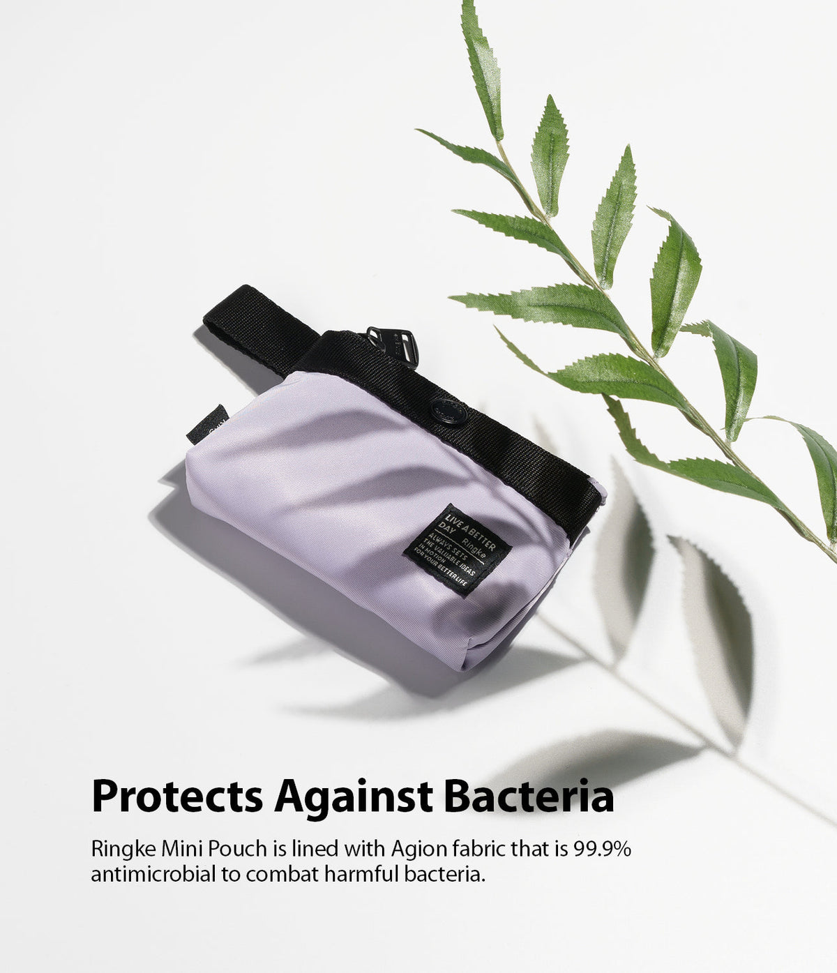 Mini Pouch | 2-Way Bag Miniature - Lavender mini pouch with black trim and logo tag, placed on white surface with green leaf.