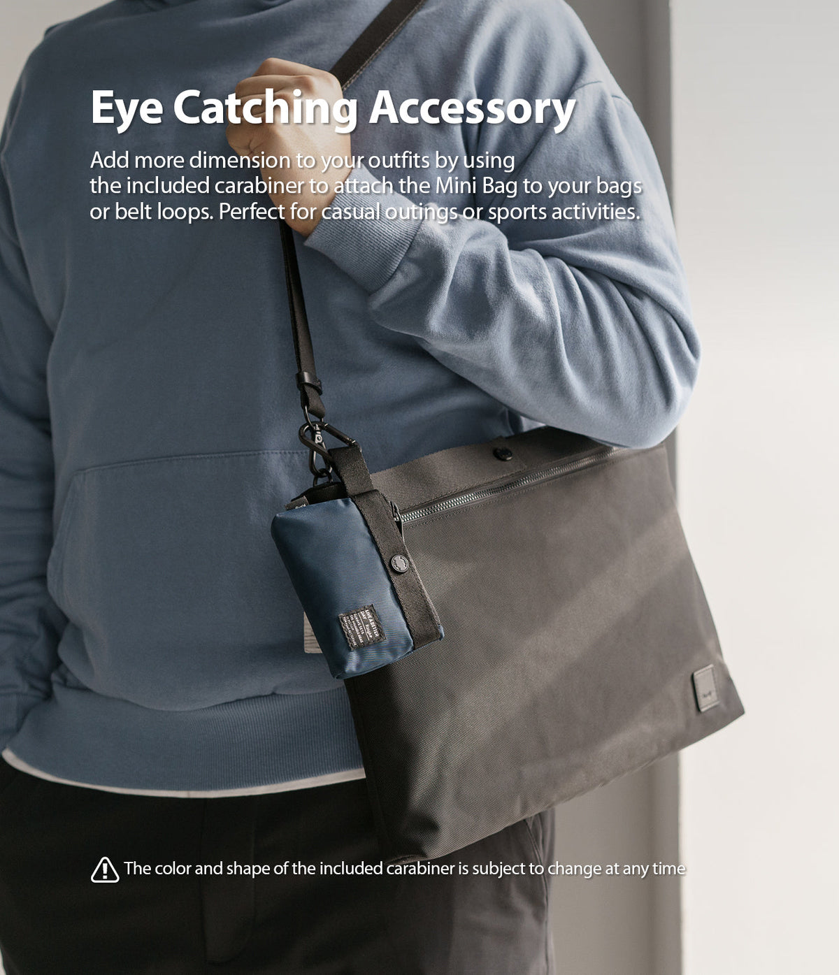 Mini Pouch | 2-Way Bag Miniature - A navy mini pouch clipped to a black shoulder bag strap with a carabiner.