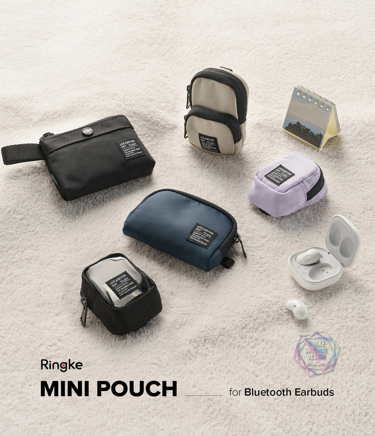 Mini Pouch | Block - Assorted small fabric pouches in black, blue, beige, and lavender arranged on a white textured surface.