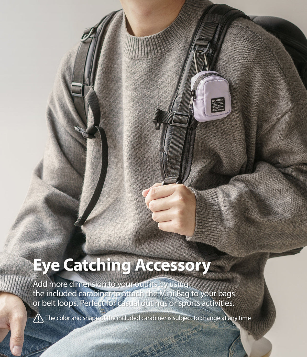 Mini Pouch | Block - A light purple mini pouch clipped to a backpack strap with a carabiner, worn by a person in a sweater.