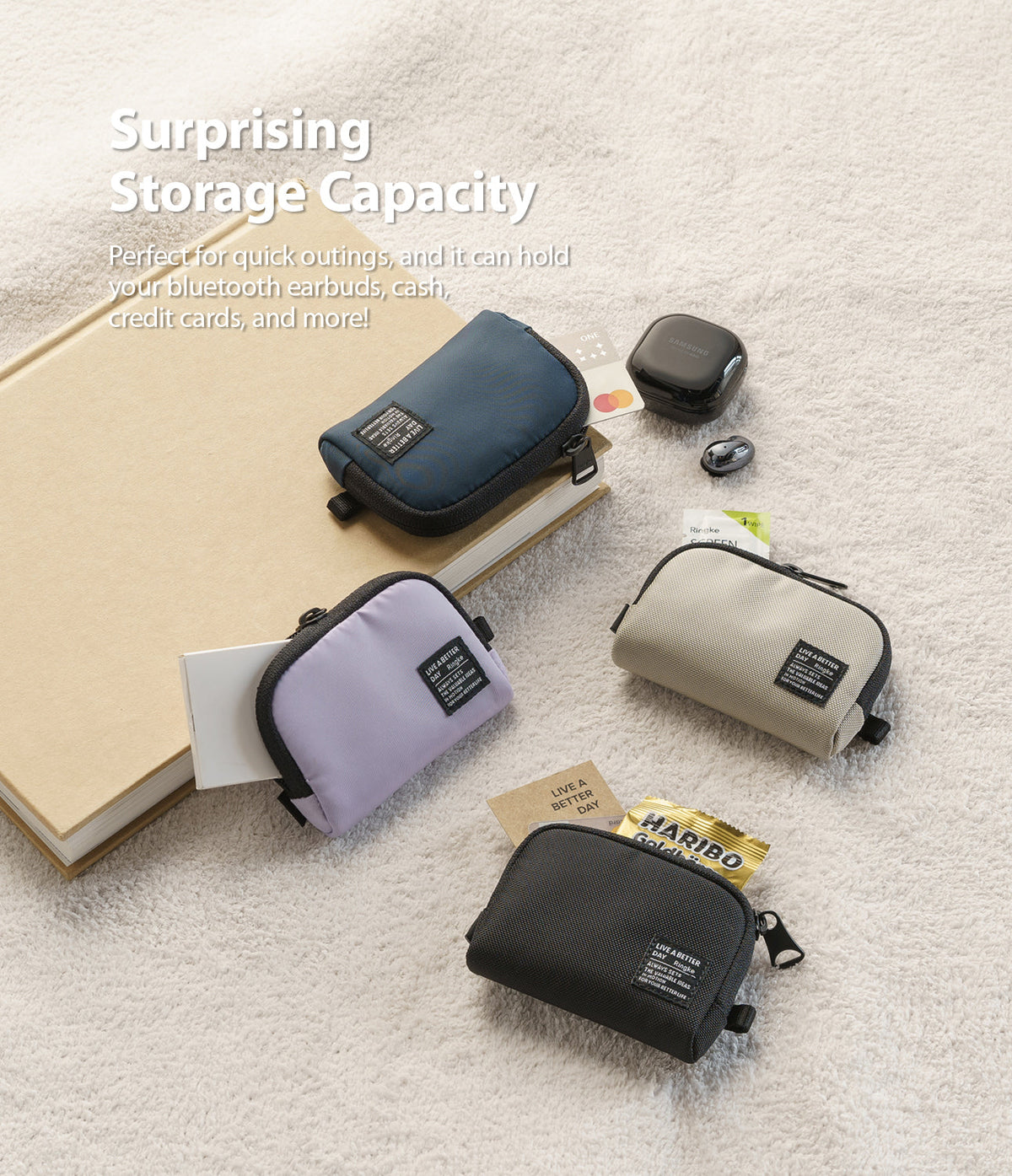 Mini Pouch | Half-Pocket - Four small zippered pouches in blue, purple, beige, and black arranged on a textured surface.