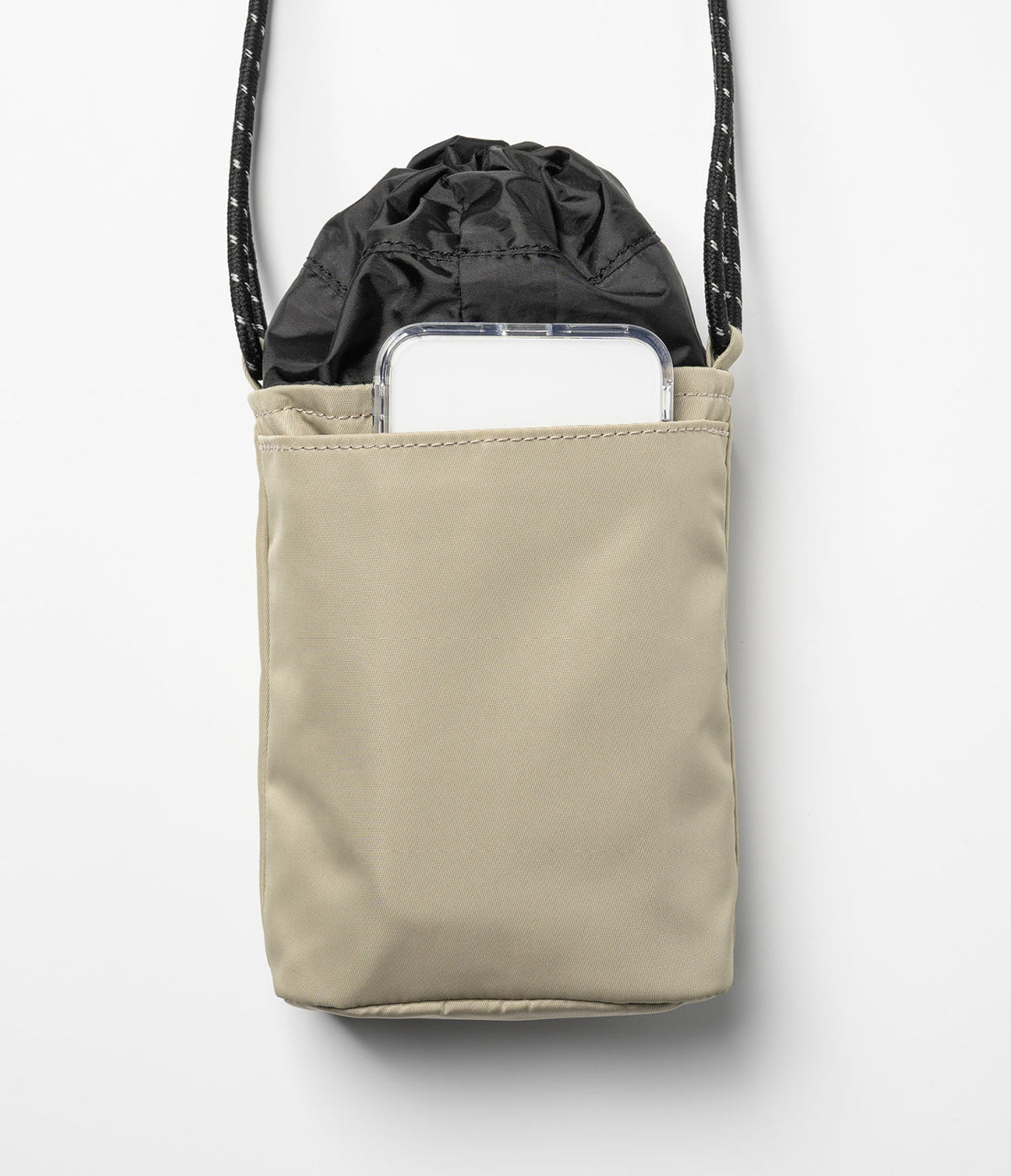 Mini Cross Bag | Bucket Bag - Beige nylon bucket bag with a black drawstring top and a smartphone in the front pocket.