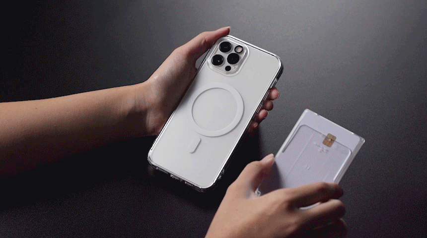 Card Holder | Magnetic Slot - A hand magnetically attaches a slim white card holder to the back of a clear iPhone case.
