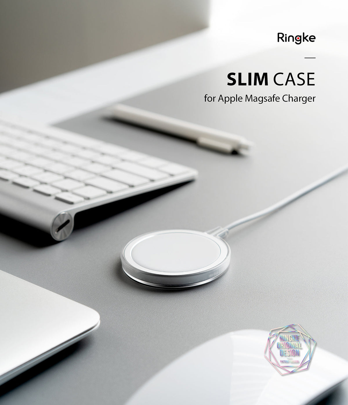 MagSafe Charger Case | Slim - A clear protective case on an Apple MagSafe charger resting on a grey desk with a keyboard.