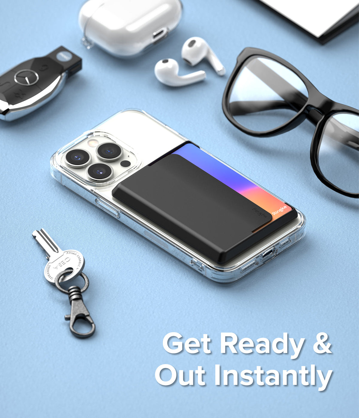 Card Holder | Magnetic Side Slot - Black magnetic card holder attached to a clear iPhone case on a blue surface with accessories.