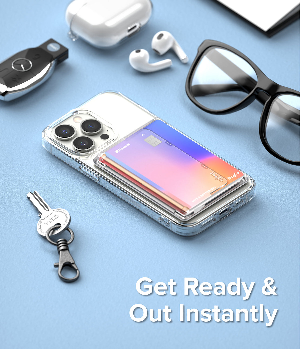 Card Holder | Magnetic Side Slot - A clear phone case with a magnetic card holder attached, surrounded by everyday carry items on a blue surface.