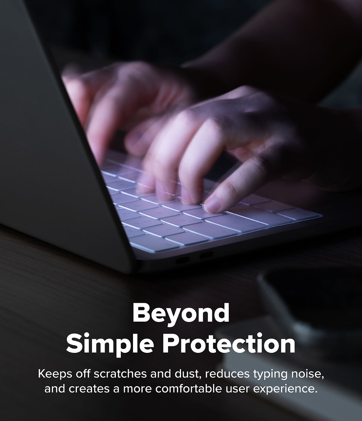 MacBook Neo Case + Protector - A close-up of hands typing on a laptop keyboard in a dim environment, with overlaid text reading 'Beyond Simple Protection' and a descriptive marketing phrase about scratch resistance and typing comfort.