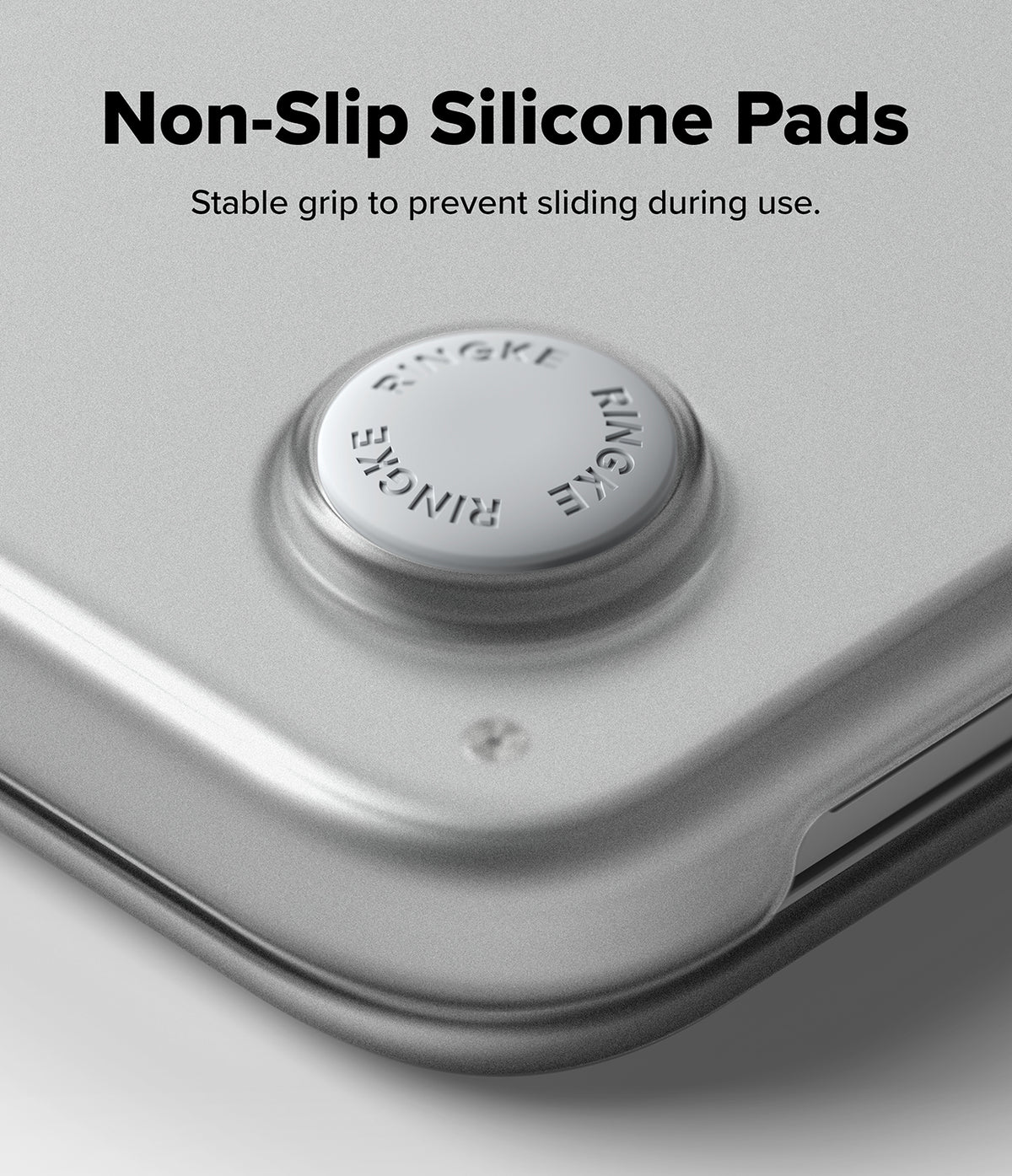 MacBook Neo Case + Protector all-groups - Close-up of a silver metallic device corner with a circular non-slip silicone pad, with text reading 'Non-Slip Silicone Pads' and 'Stable grip to prevent sliding during use.'.