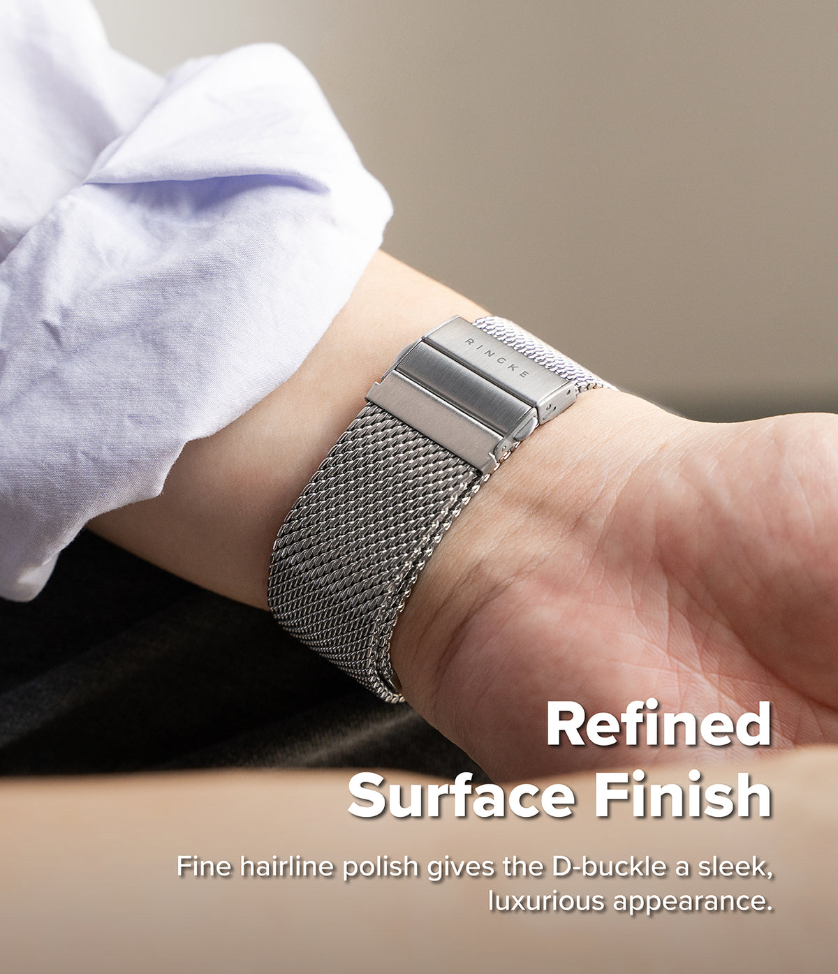 Apple Watch 49·46·45·44 mm | Metal One Mesh - A close-up of a silver metal watch band with a mesh pattern and a rectangular buckle, worn on a person's wrist. The person is wearing a light-colored shirt cuff.