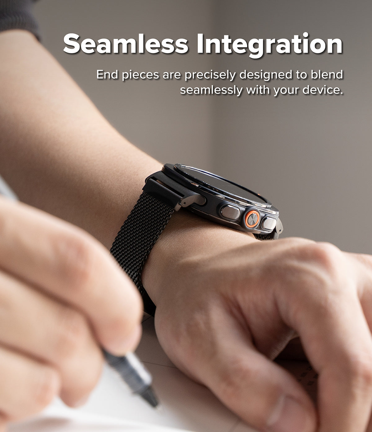 Galaxy Watch Ultra 2 / 1 | Metal One Mesh - A close-up of a smartwatch with a black mesh band worn on a person's wrist, with overlaid text reading 'Seamless Integration' and smaller copy about end pieces blending seamlessly with the device.