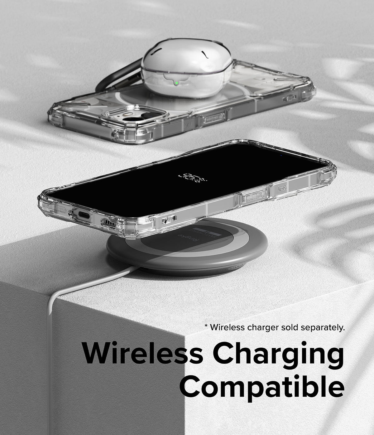 Nothing Phone (2) Case | Fusion-X - Clear phone case on a wireless charging pad with a white earbud case on top.