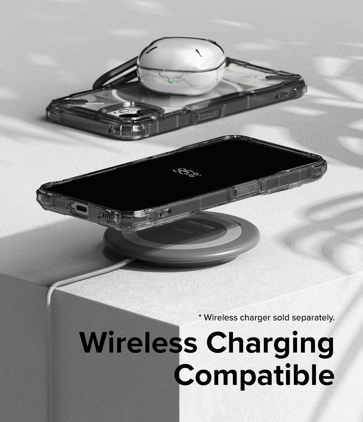 Nothing Phone (2) Case | Fusion-X - A Nothing Phone (2) in a clear case wirelessly charging on a circular pad.
