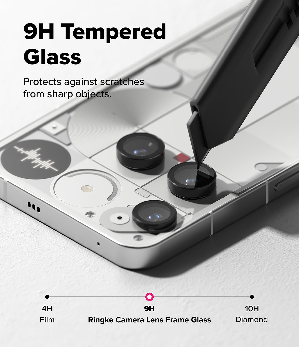 Nothing Phone (3) | Camera Glass - A utility knife blade touches a 9H tempered glass camera lens protector on a Nothing phone.