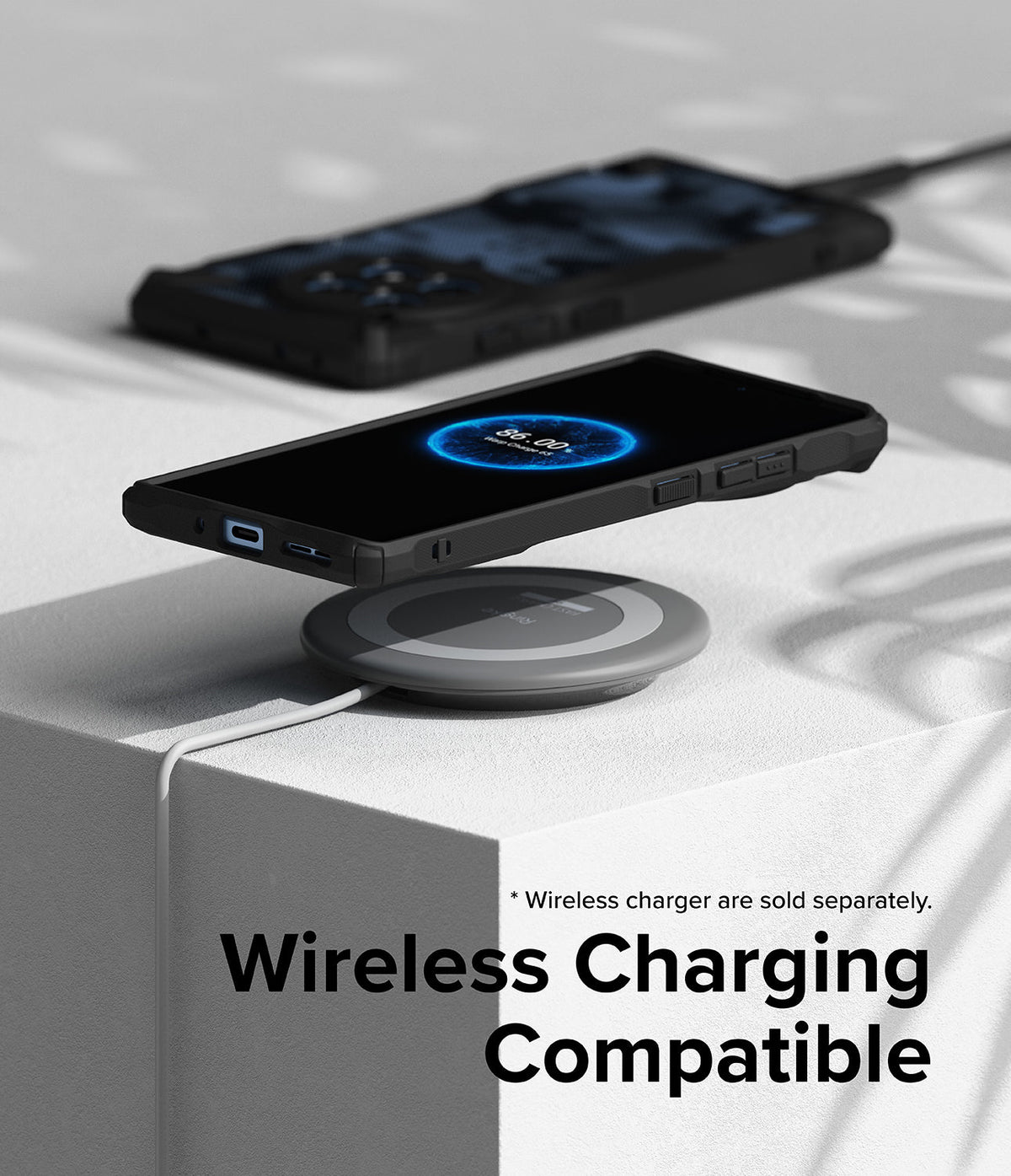 OnePlus 12R Case | Fusion-X - A OnePlus 12R in a black Fusion-X case charging wirelessly on a grey pad on a white surface.