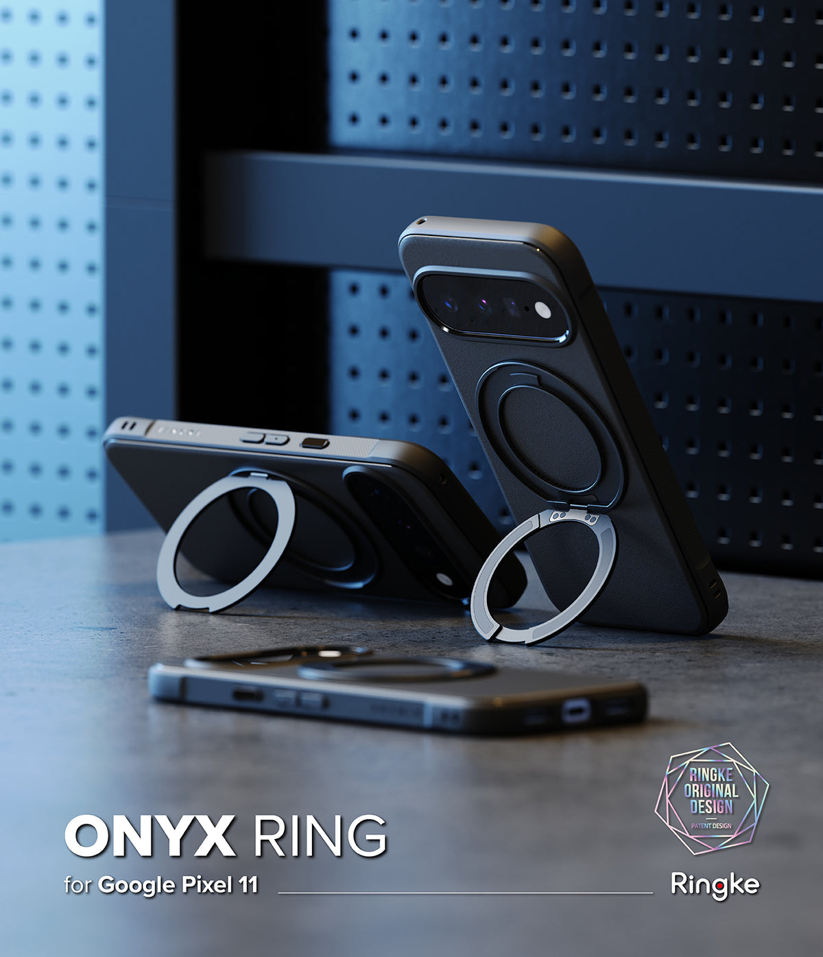 Google Pixel 11 Case | Onyx Ring - Three black phone cases with circular magnetic ring stands are displayed on a dark tabletop against a blue perforated panel background. One case stands upright holding a phone, one lies horizontal, and one is shown folded flat.