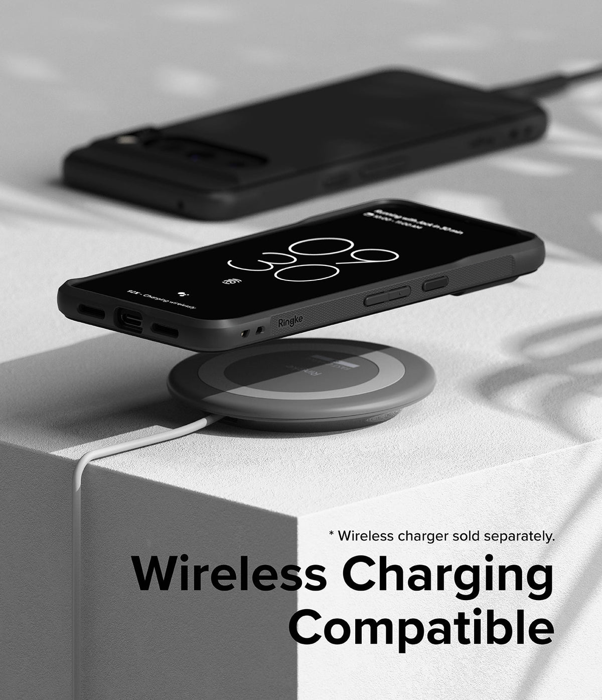 Google Pixel 8 Pro Case | Onyx - A black phone in an Onyx case charging wirelessly on a circular pad atop a white block.