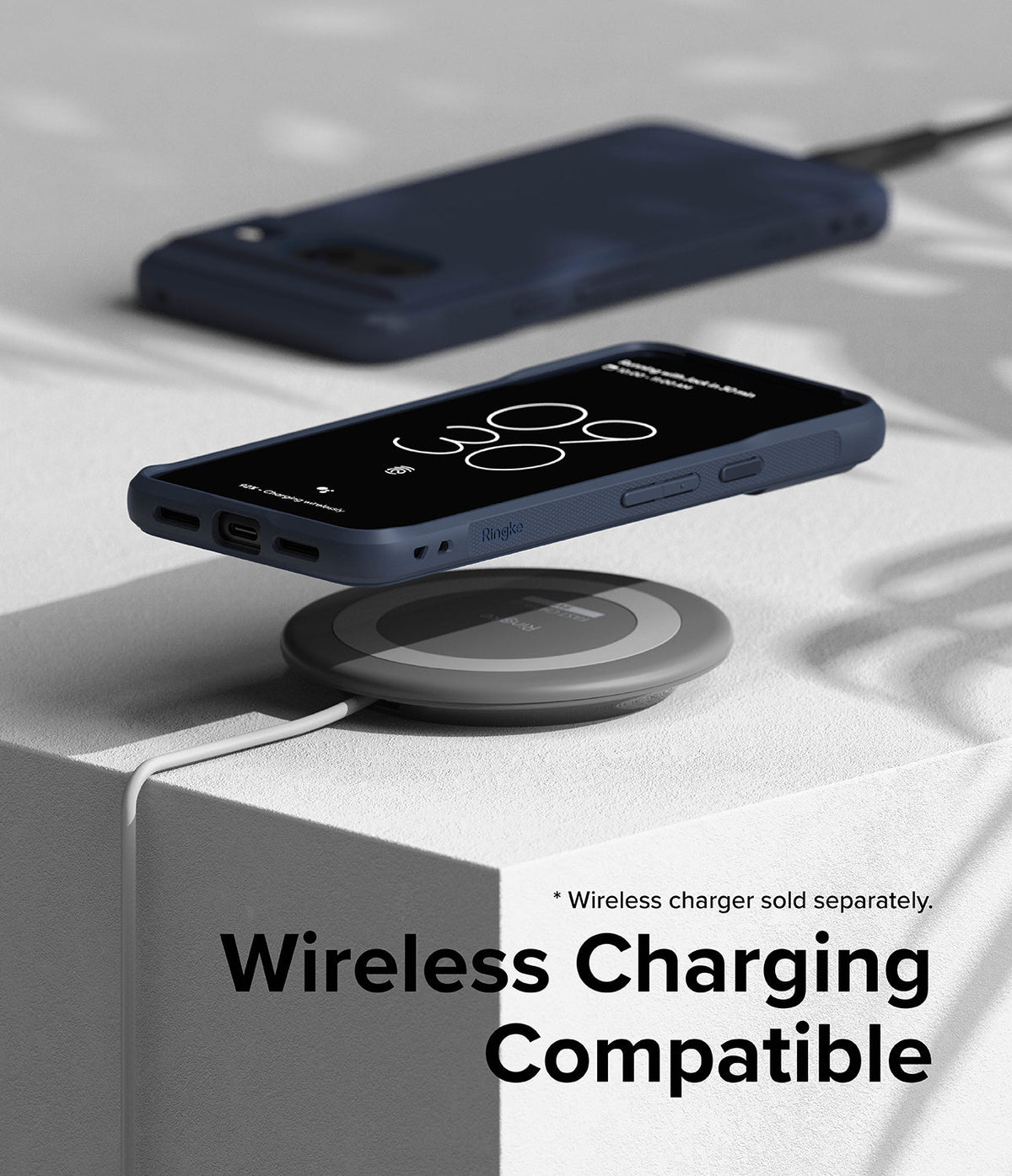 Google Pixel 8 Case | Onyx - A navy blue phone case on a wireless charging pad with a white block background.