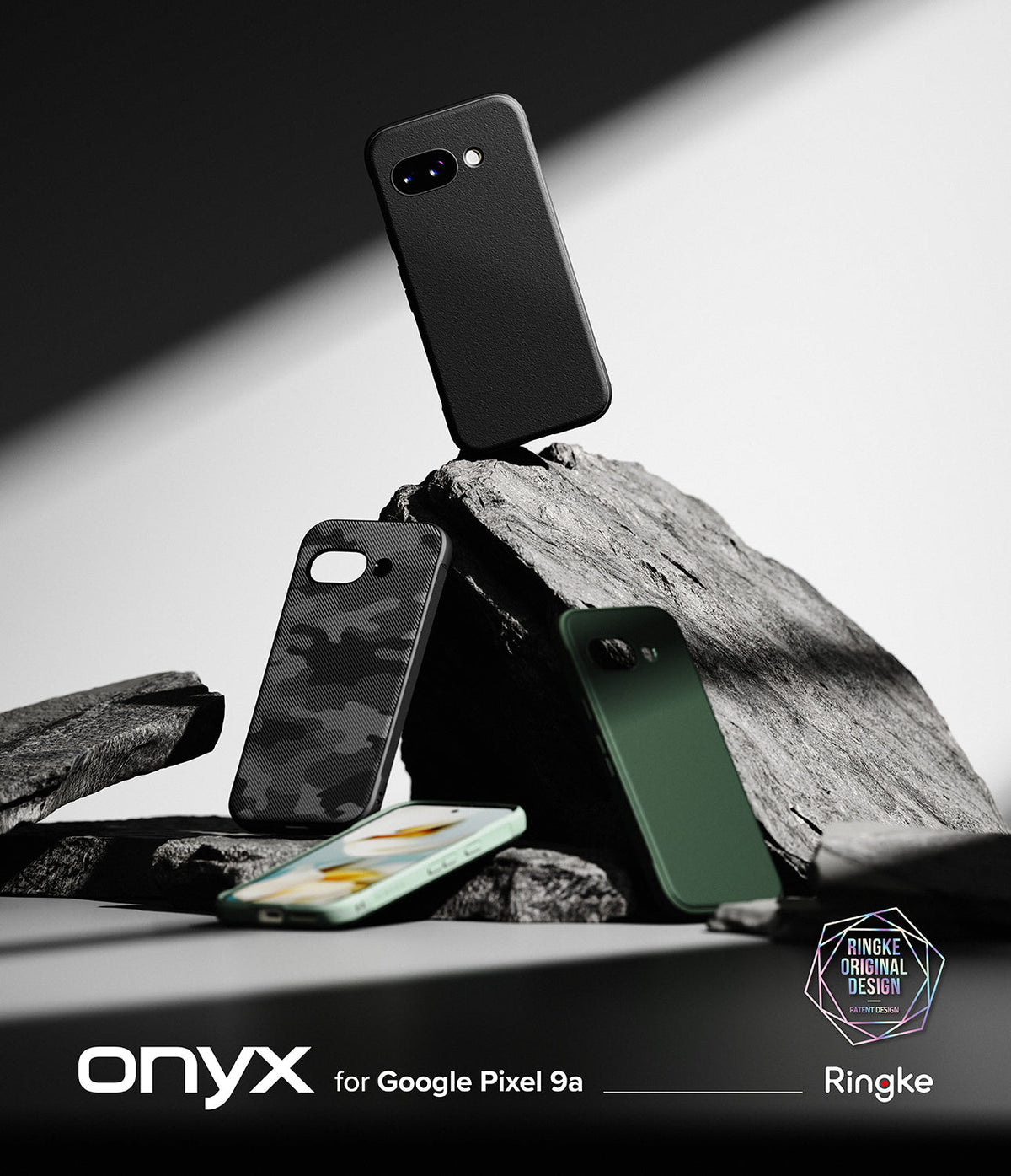 Google Pixel 9a Case | Onyx - Three textured phone cases and a smartphone arranged on jagged rocks against a dark background.