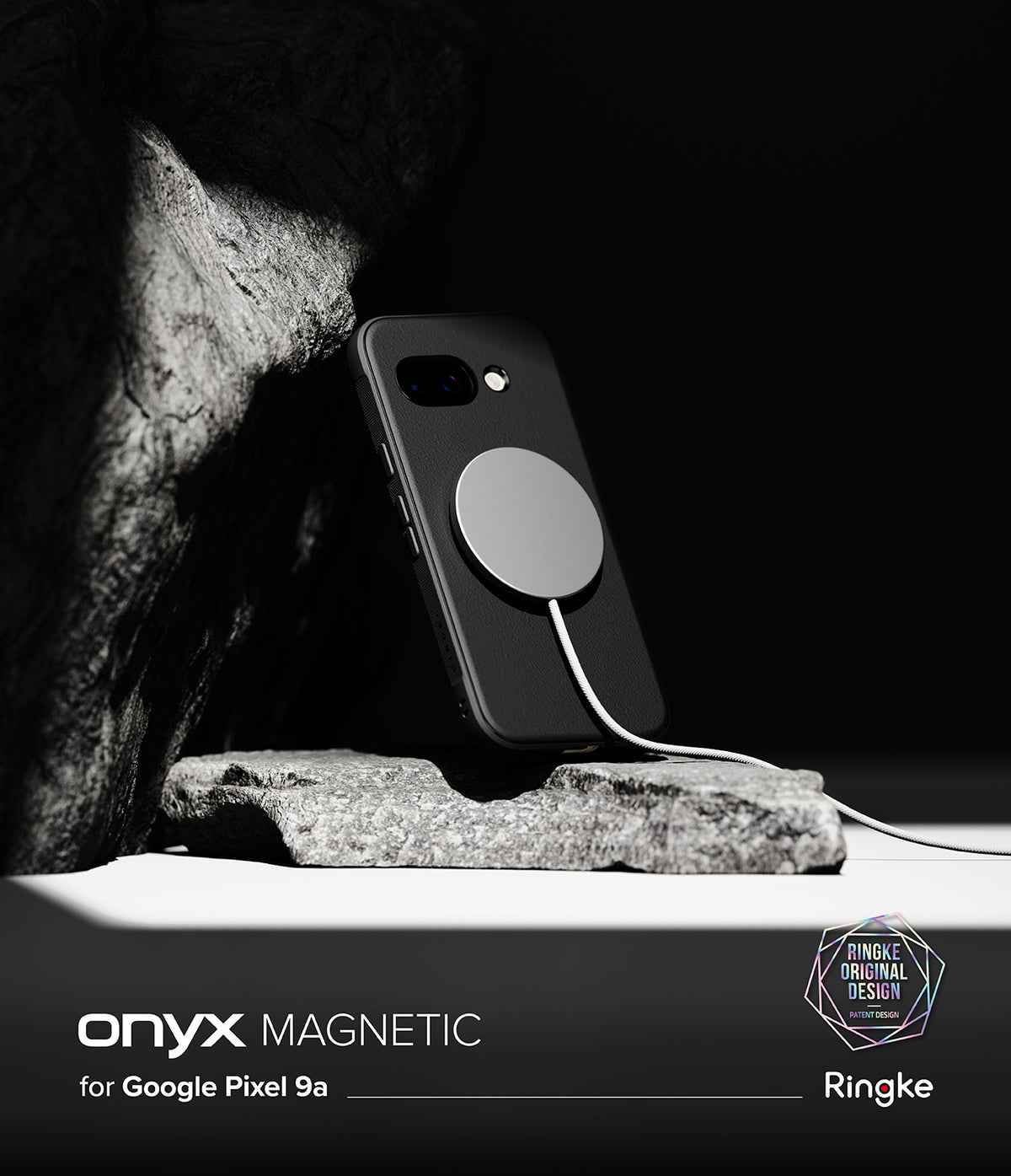 Google Pixel 9a Case | Onyx Magnetic - Black phone case with a magnetic charger attached, resting against a textured rock.