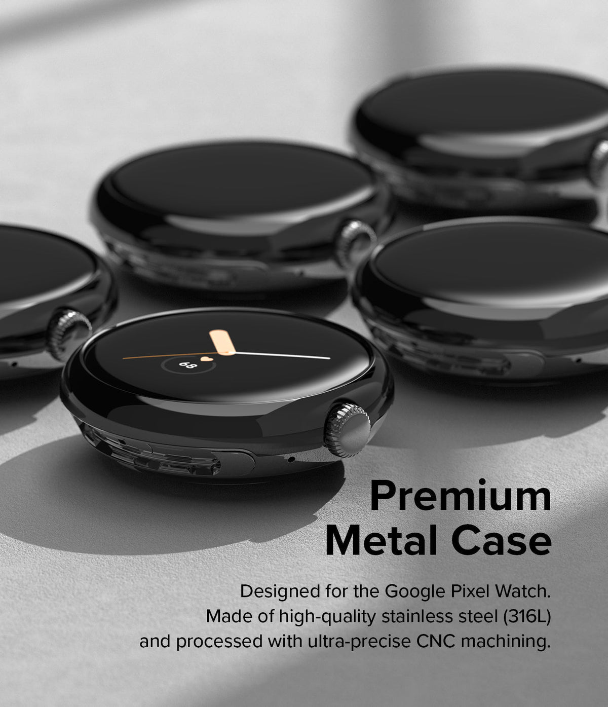 Google Pixel Watch 41mm | Bezel Styling - Multiple glossy black stainless steel watch cases arranged on a gray surface.