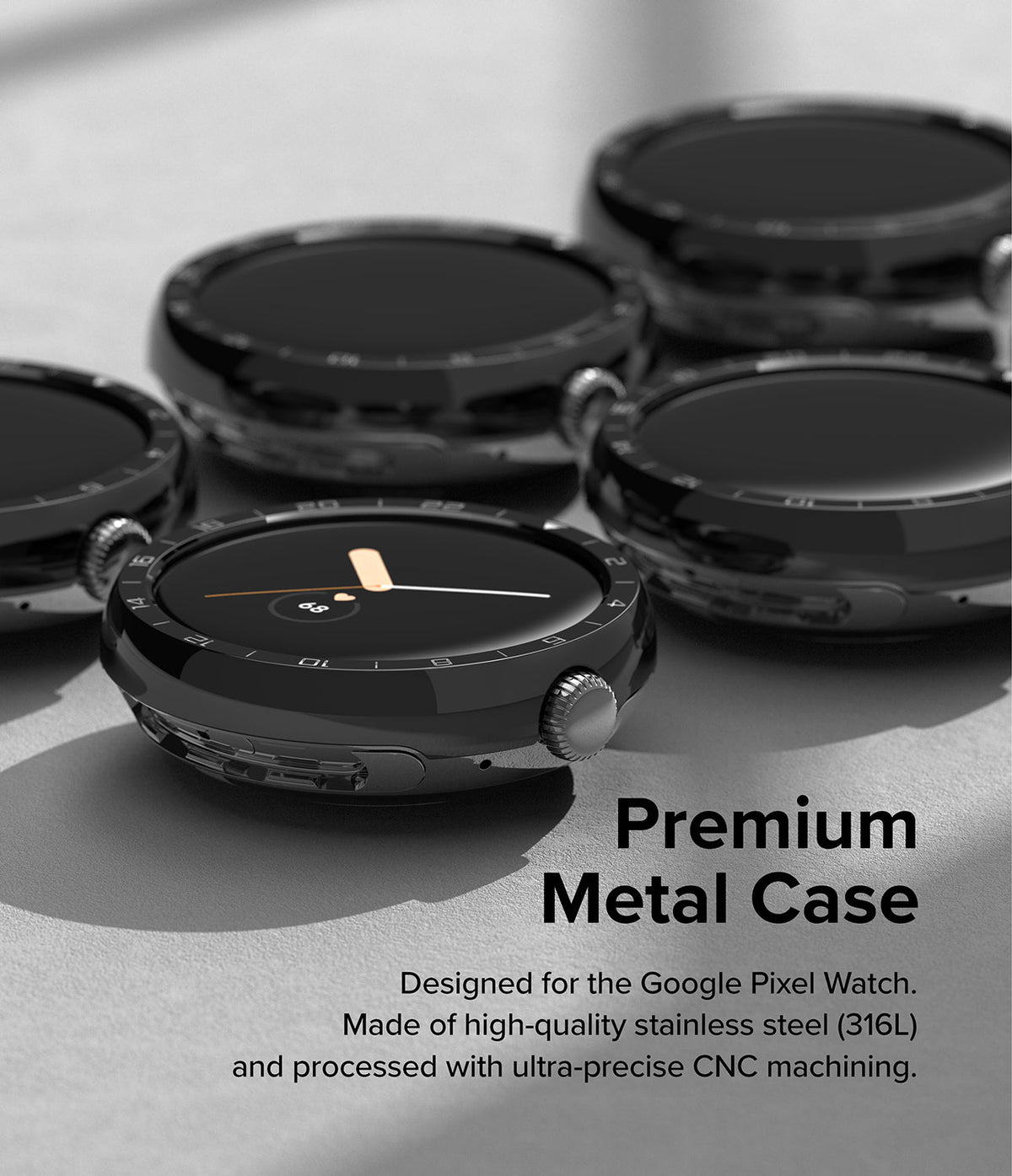 Google Pixel Watch 41mm | Premium Bezel Styling - Multiple glossy black stainless steel watch bezels on a gray surface.