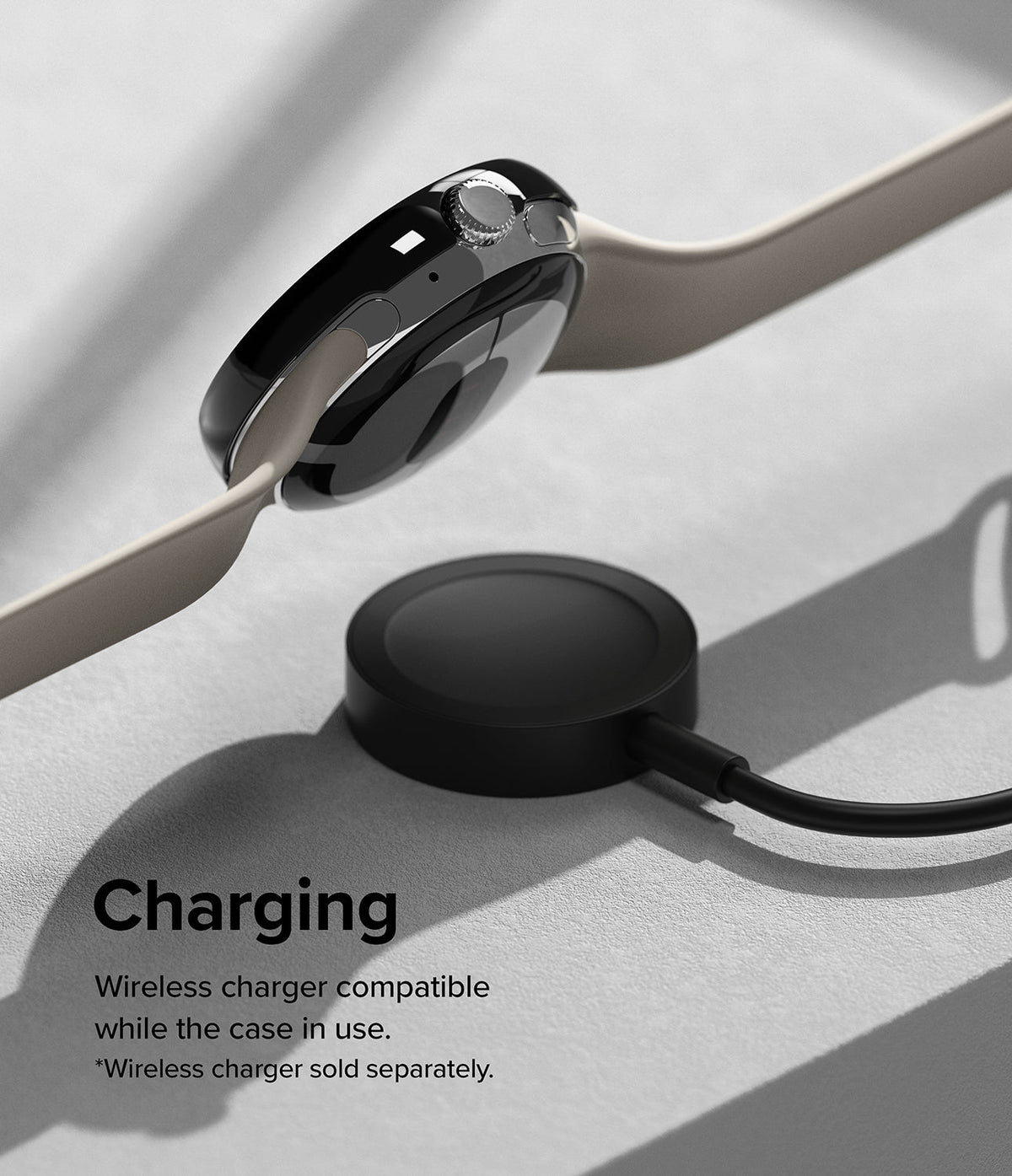 Google Pixel Watch 41mm | Premium Bezel Styling - A black smartwatch with a beige band hovering above a wireless charging puck.