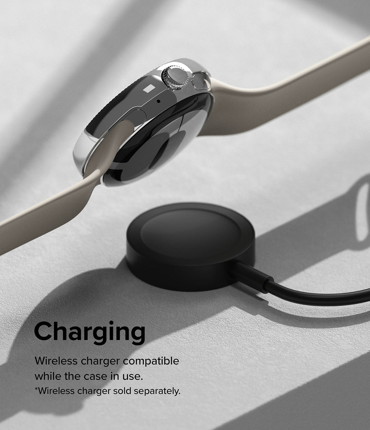 Google Pixel Watch 41mm | Premium Bezel Styling - A silver-cased smartwatch with a beige band hovering above a black wireless charger.
