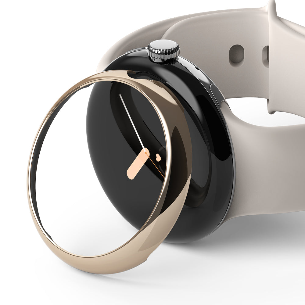 Google Pixel Watch 41mm | Bezel Styling - A gold-toned circular bezel accessory hovering over a black Pixel Watch.