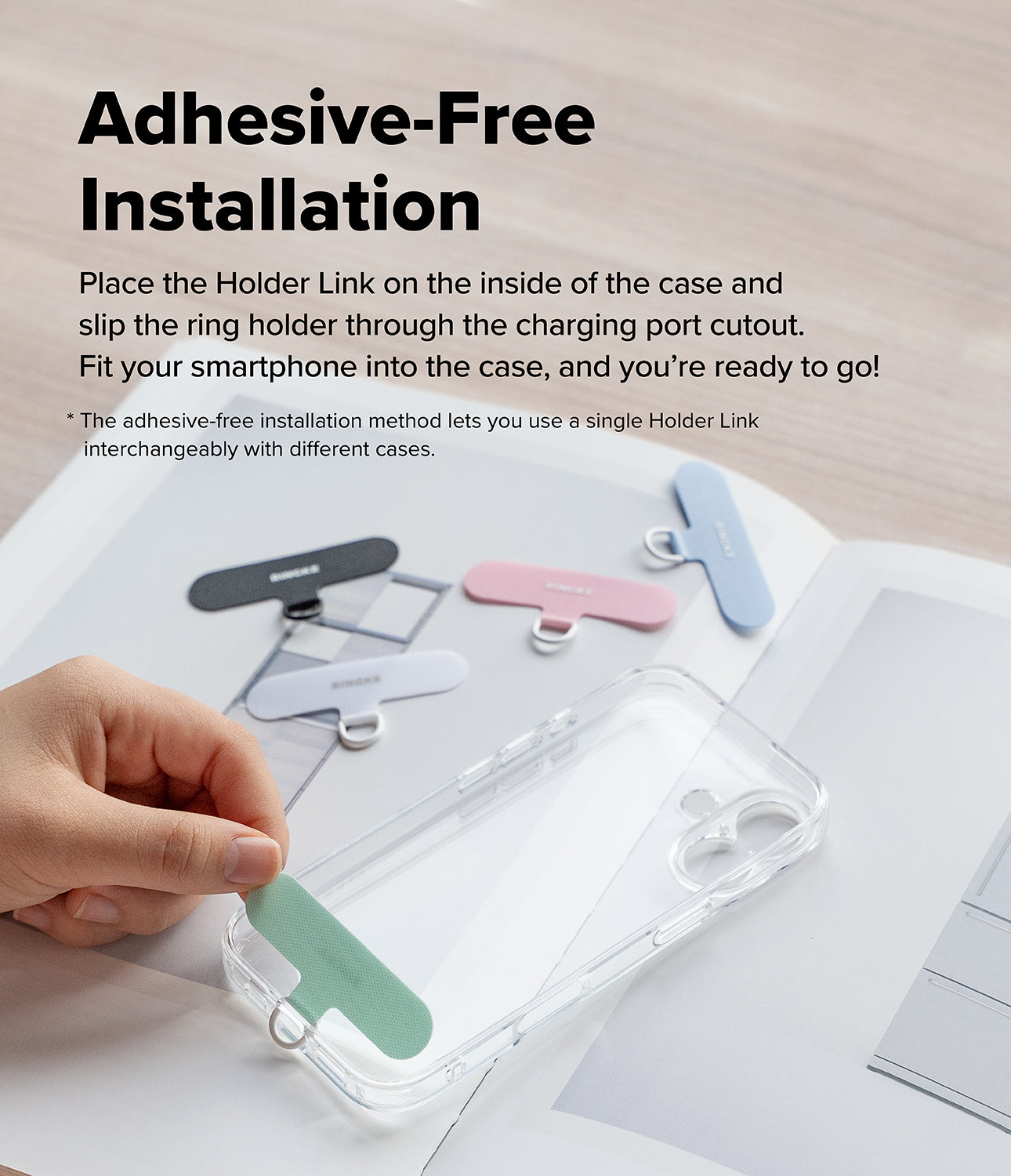 Holder Link Puffer | Finger - Hand placing a green adhesive-free phone strap into a clear phone case with other colors nearby.