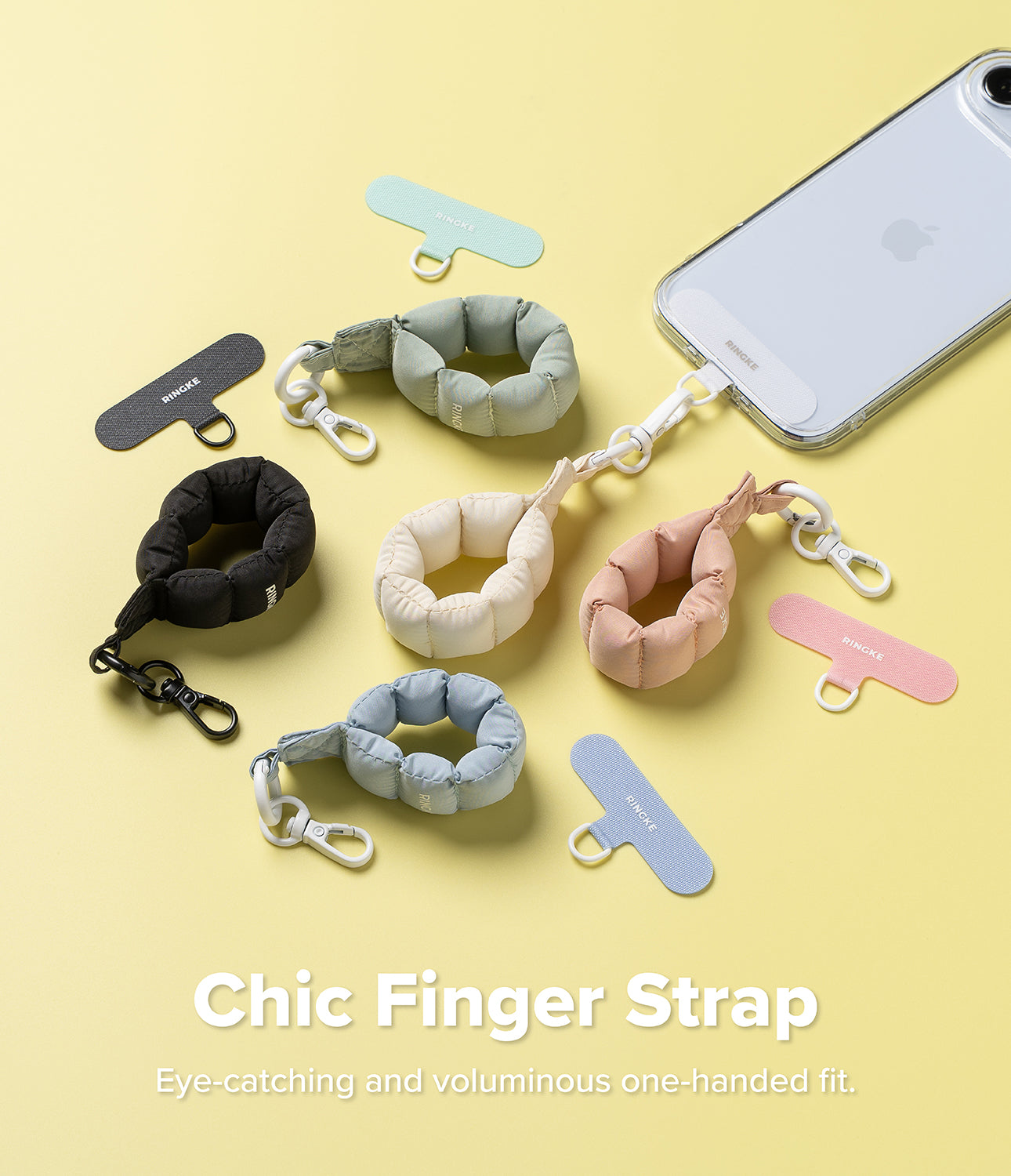 Holder Link Puffer | Finger - Colorful, puffy ring-shaped phone straps with clips and adhesive tabs on a yellow background.