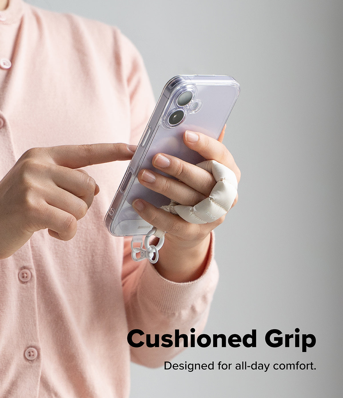Holder Link Puffer | Finger - A person holds a smartphone with a white, cushioned finger strap attached for secure grip.