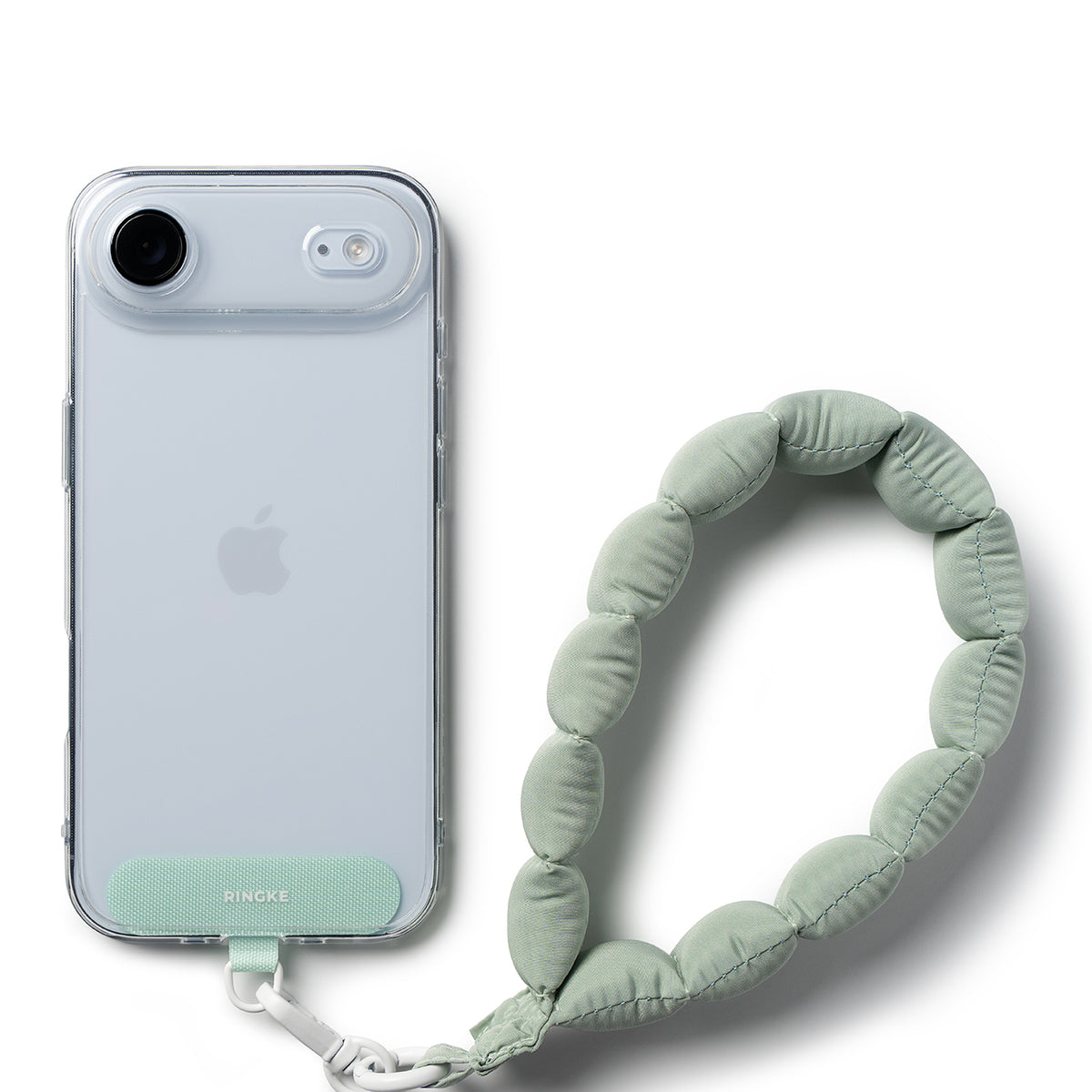 Holder Link Puffer | Hand - Sage green quilted puffer wrist strap attached to a clear phone case with a matching tab.
