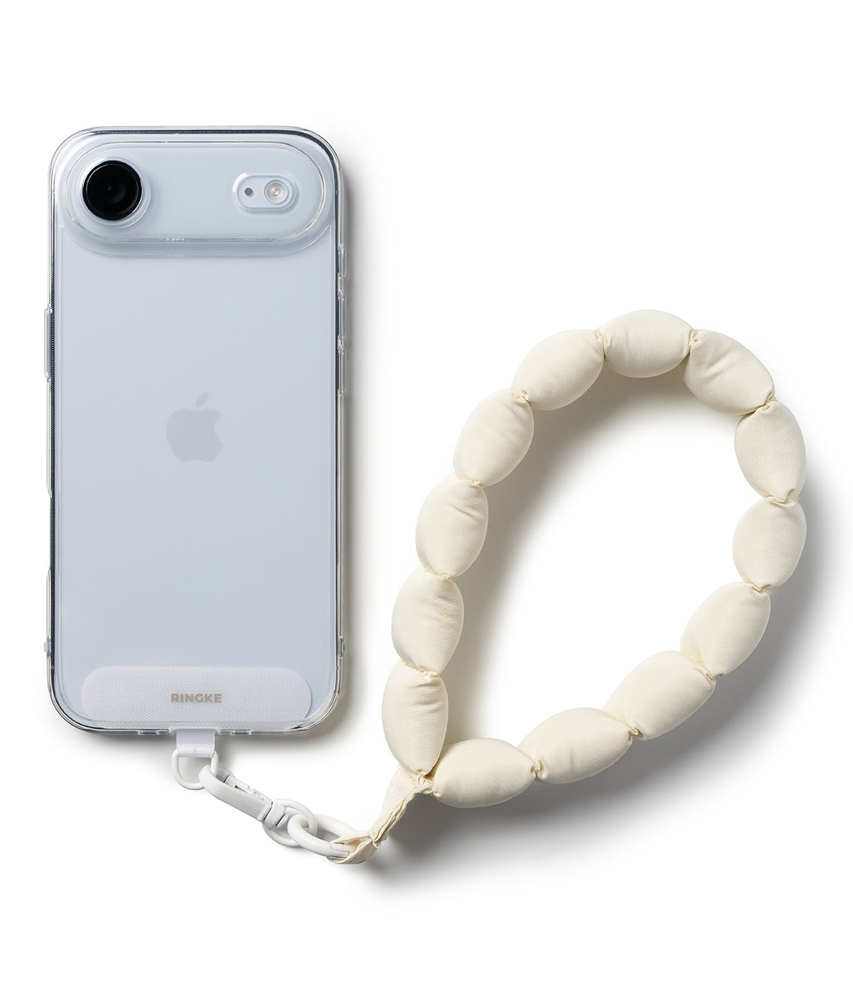 Holder Link Puffer | Hand - A clear phone case attached to a cream-colored, pillowy, bead-style wrist strap.