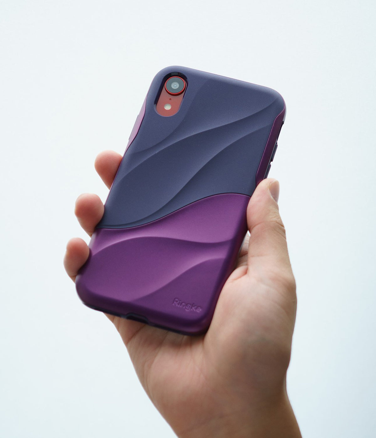iPhone XR Case | Wave - A hand holds a purple and dark blue two-toned phone case with a textured, wavy design.