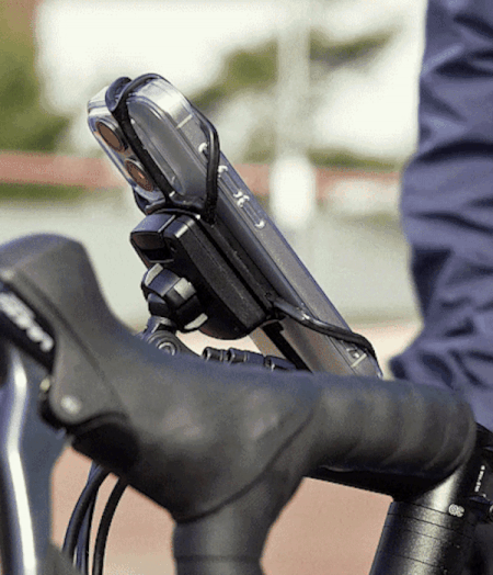 Quick & Go | Grip Bike Mount - A smartphone secured to bicycle handlebars with a black silicone strap mount.