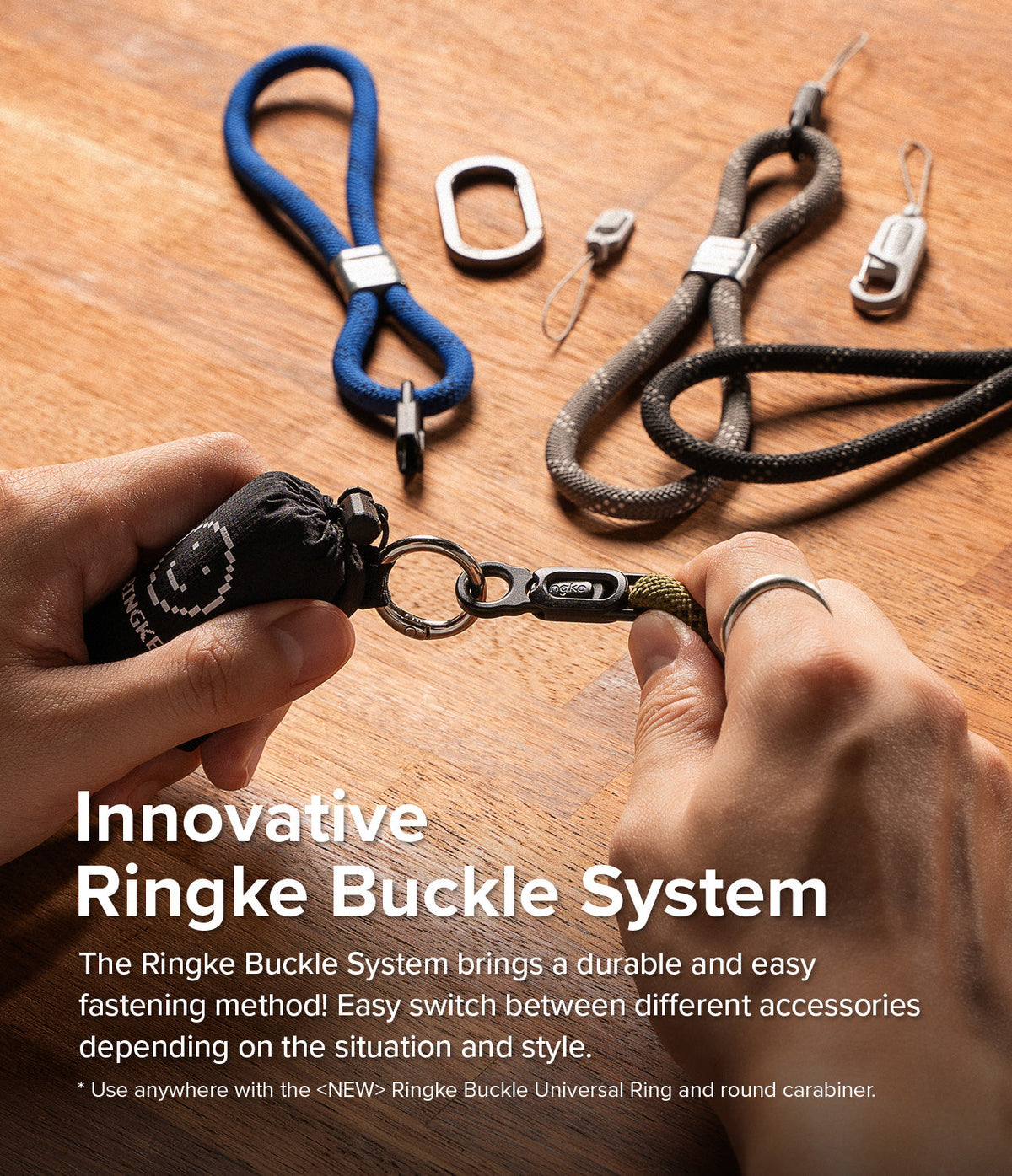 Rope Hand Strap - Hands attaching a black rope strap to a metal ring buckle on a wooden table with other strap accessories.