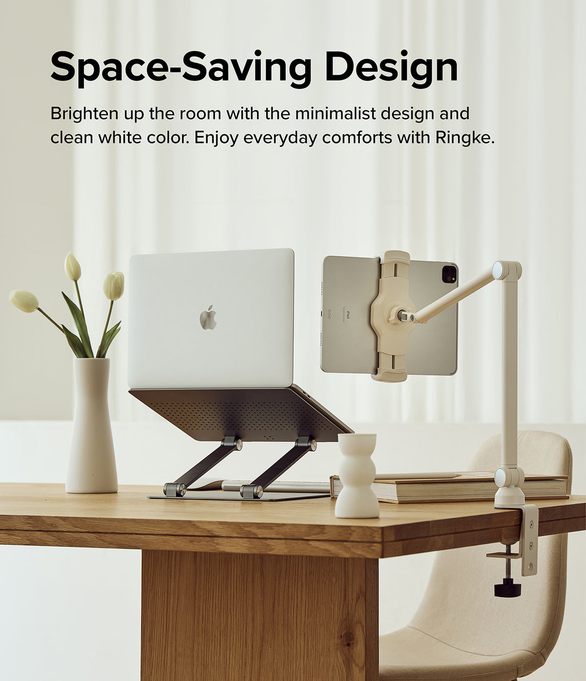 Ringke Clamp Holder - White adjustable arm clamp holding a tablet next to a laptop on a desk with a vase of tulips.
