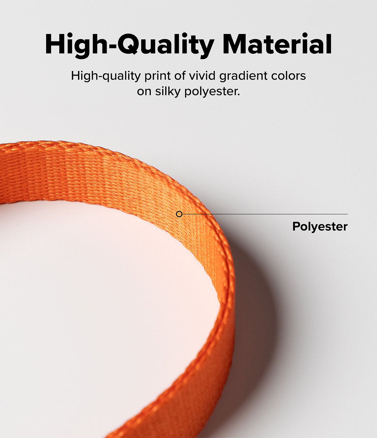 Dual Hand Slim Strap - Close-up of a vibrant orange polyester strap with a label pointing to the woven fabric texture.
