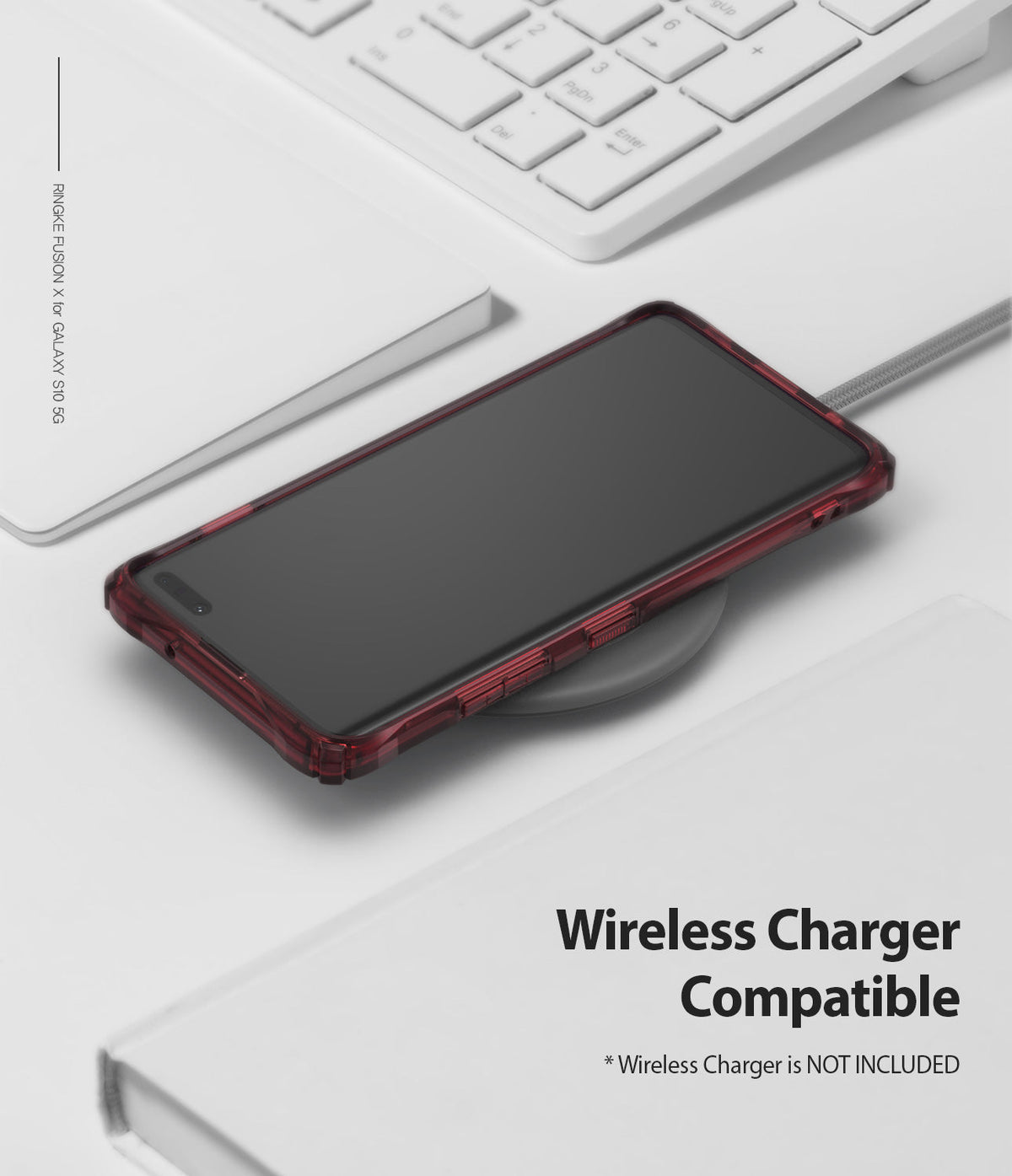 Galaxy S10 5G Case | Fusion-X - Ruby red phone case on a wireless charger next to a white keyboard and notebook.