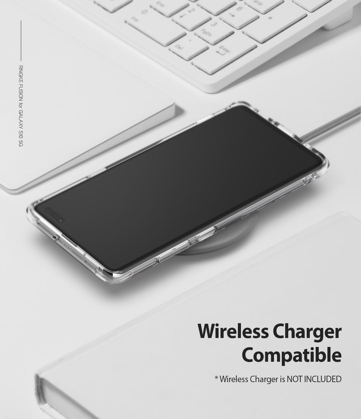 Galaxy S10 5G Case | Fusion - Clear phone case on a wireless charger next to a white keyboard and notebook.