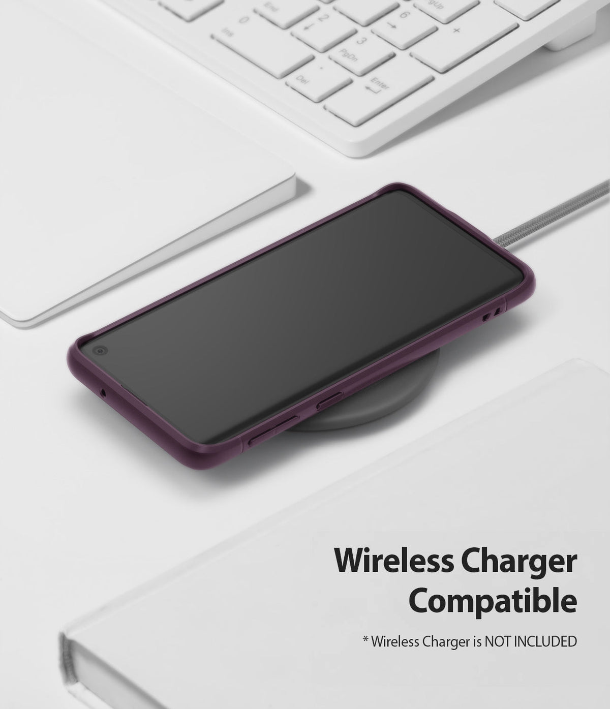 Galaxy S10 Case | Onyx - Purple Galaxy S10 in an Onyx case resting on a wireless charging pad on a white desk.