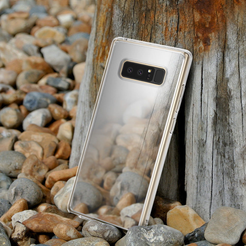Galaxy Note 8 Case | Mirror - Reflective phone case leaning against a wooden post on a rocky beach.