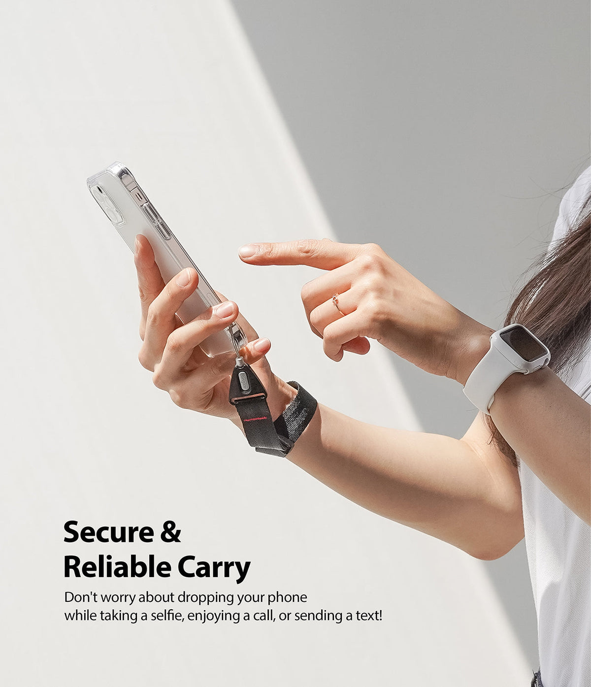 Hand Strap | Black / Neon Orange - Person holding a smartphone with a black wrist strap attached for secure carrying.