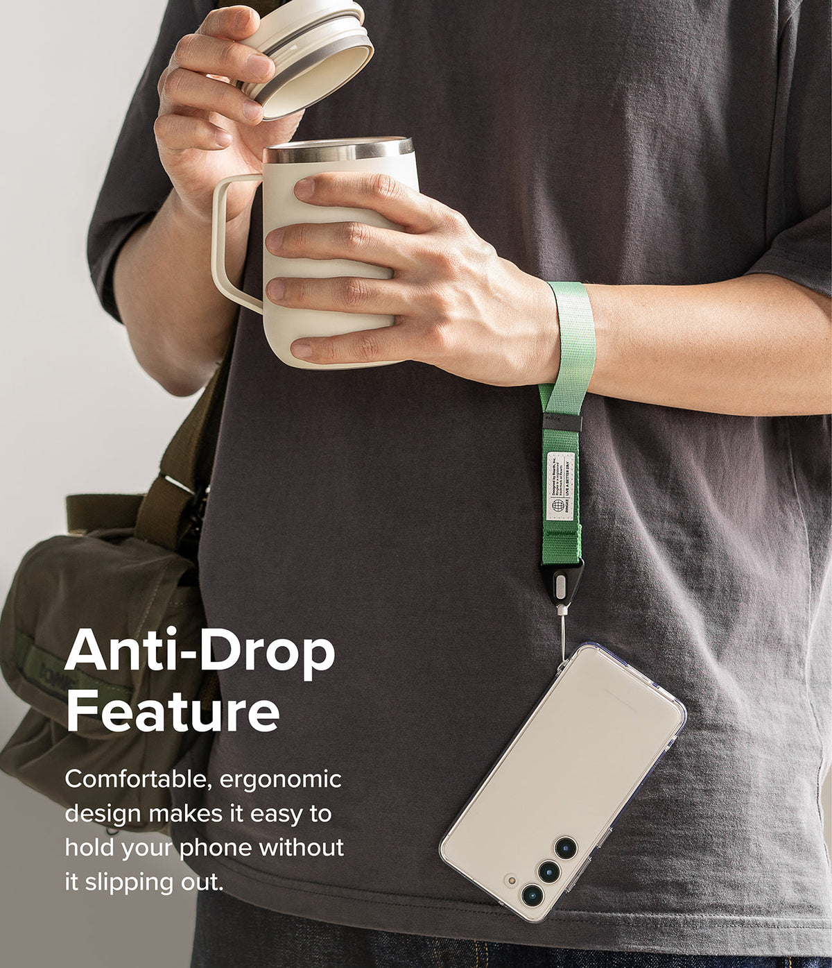 Hand Strap | Basic - A person wearing a green wrist strap attached to a smartphone while holding a coffee mug.