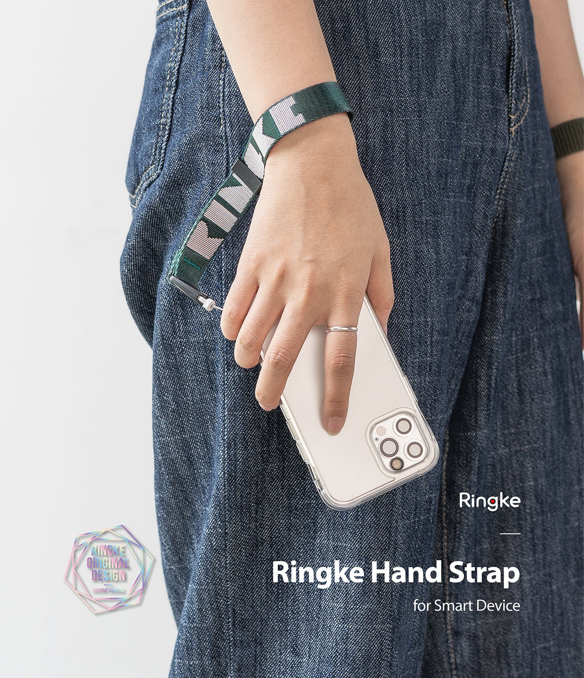Hand Strap | Lettering - A person wearing a green and white Ringke-branded fabric hand strap attached to a smartphone.