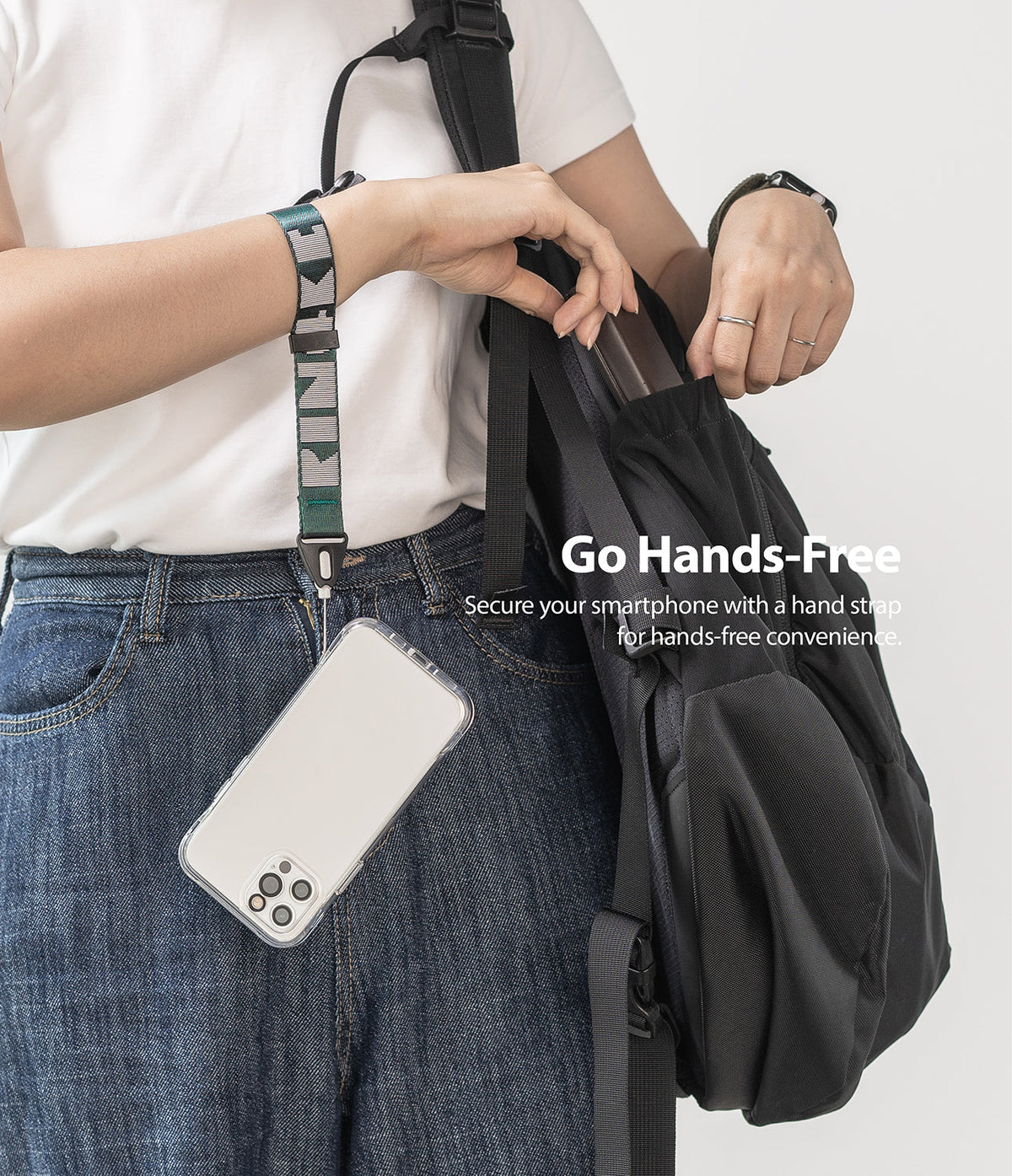 Hand Strap | Lettering - Person wearing a green and grey branded wrist strap attached to a clear smartphone case.