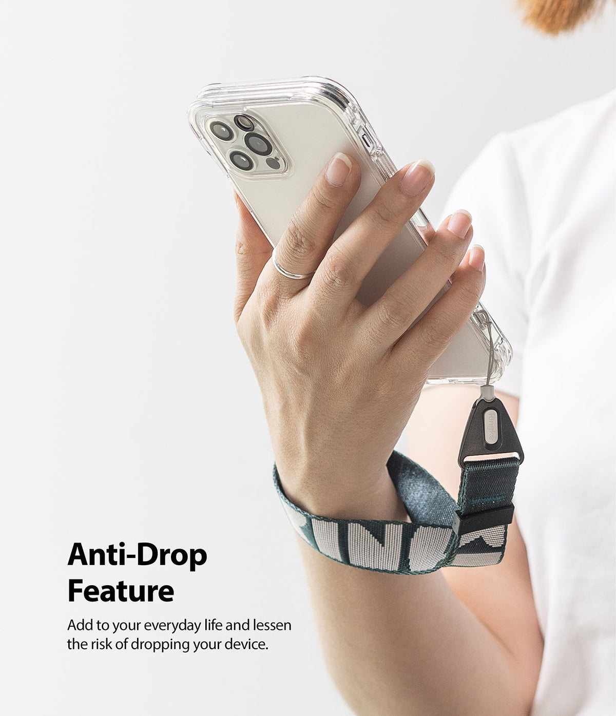 Hand Strap | Lettering - A person holding a smartphone with a green and white patterned wrist strap attached for anti-drop security.