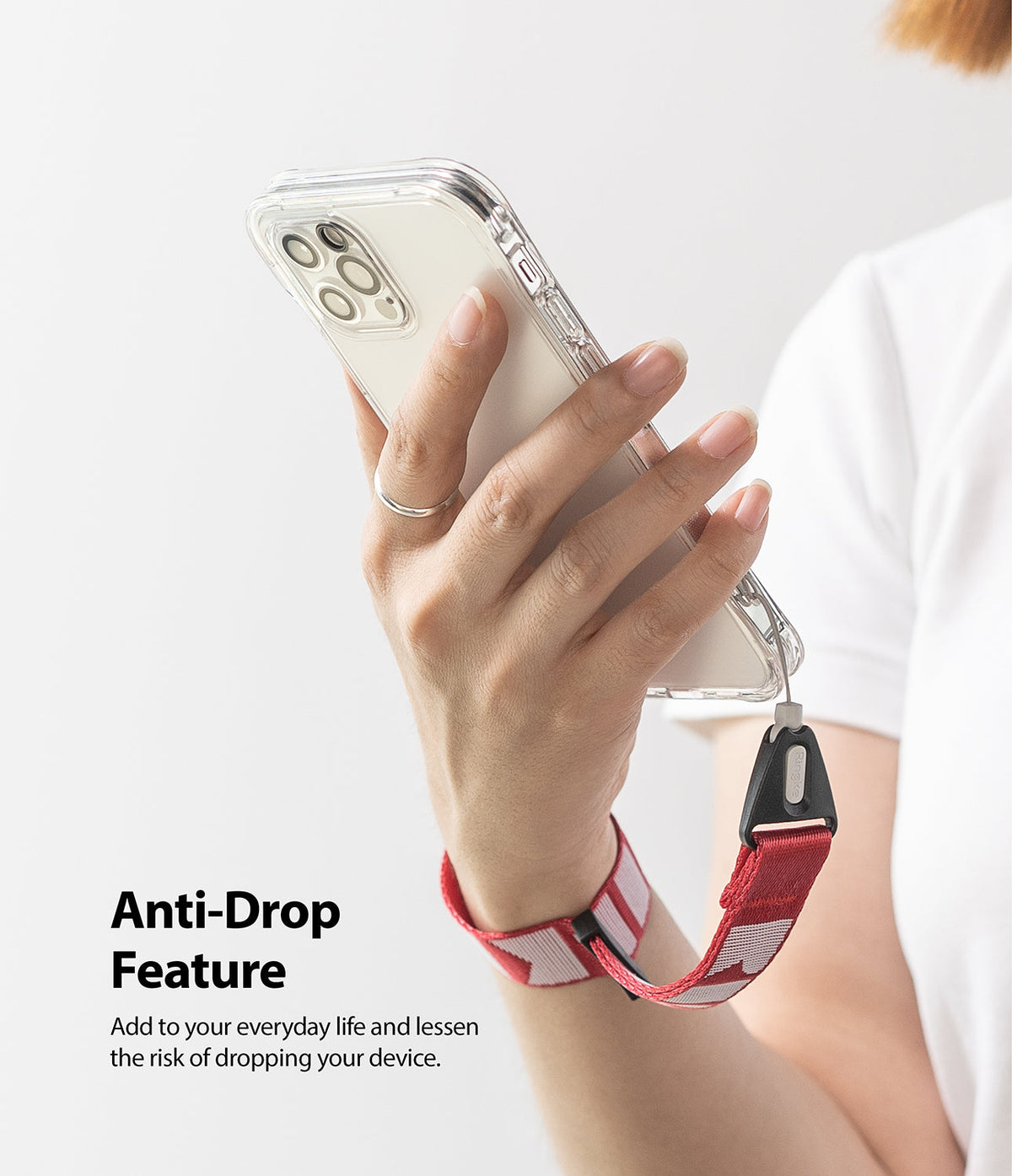 Hand Strap | Lettering - A person holding a phone with a red and white patterned wrist strap attached for anti-drop security.